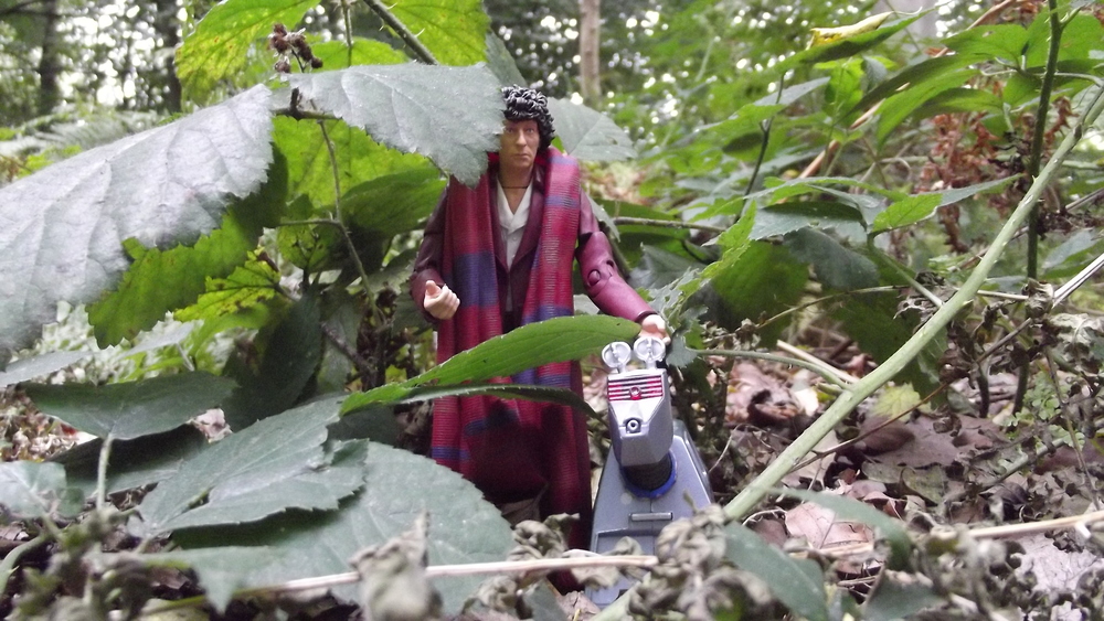 A Tom Baker action figure and a K9 emerging from the undergrowth