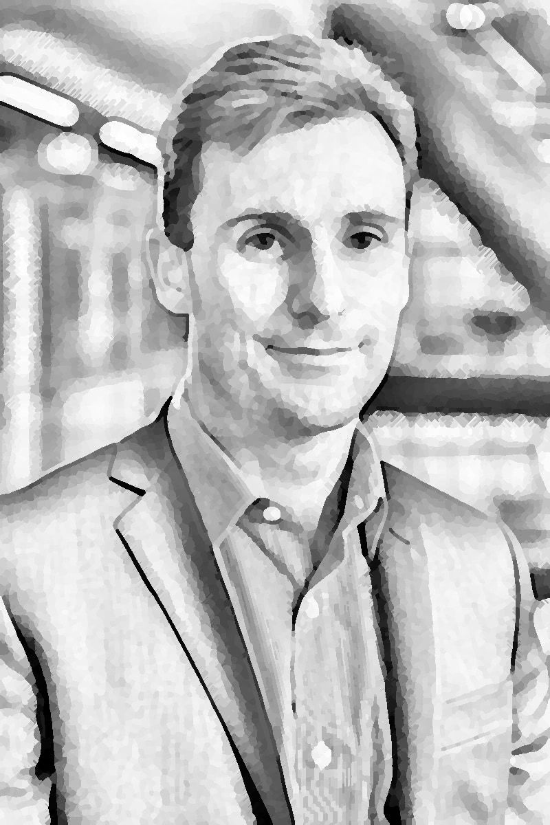 A professional-looking headshot of Mathew in a lovely jacket.