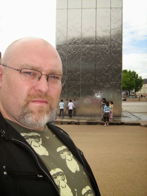 Adam standing near the Torchwood Hub in Cardiff