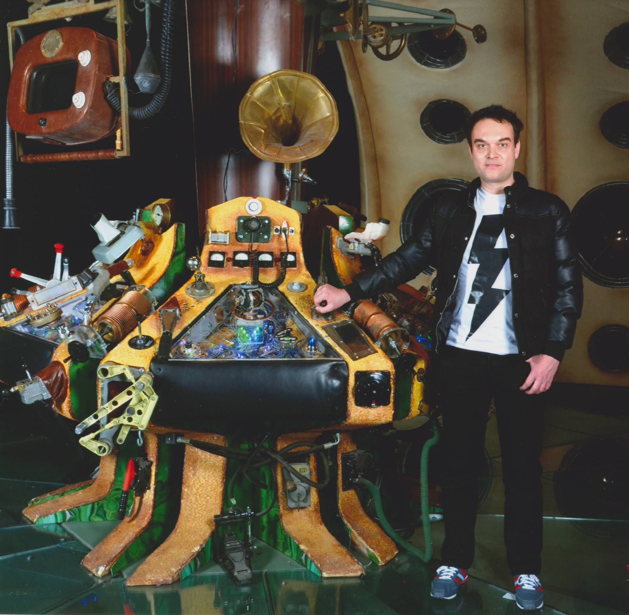 Colin standing in the dark next to Matt Smith's first TARDIS console
