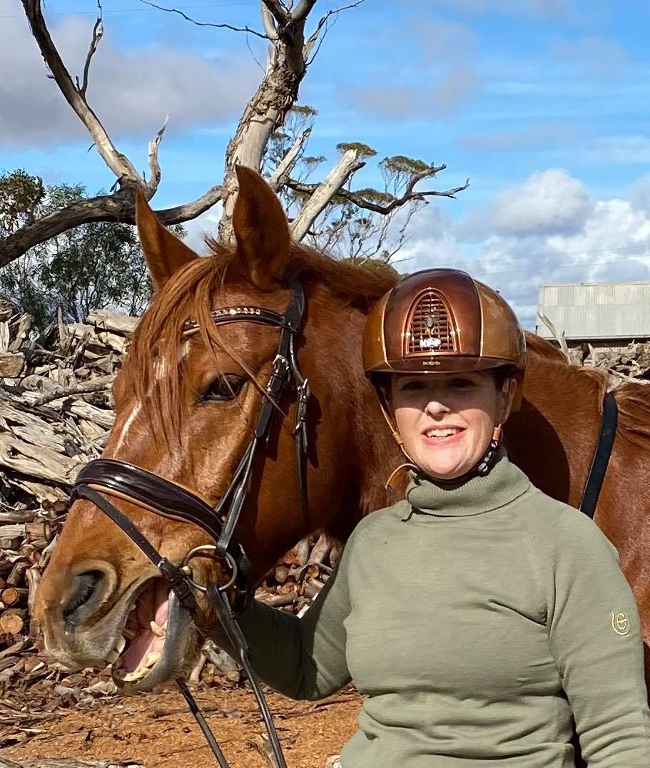 Fiona in a helmet next to a giant horse