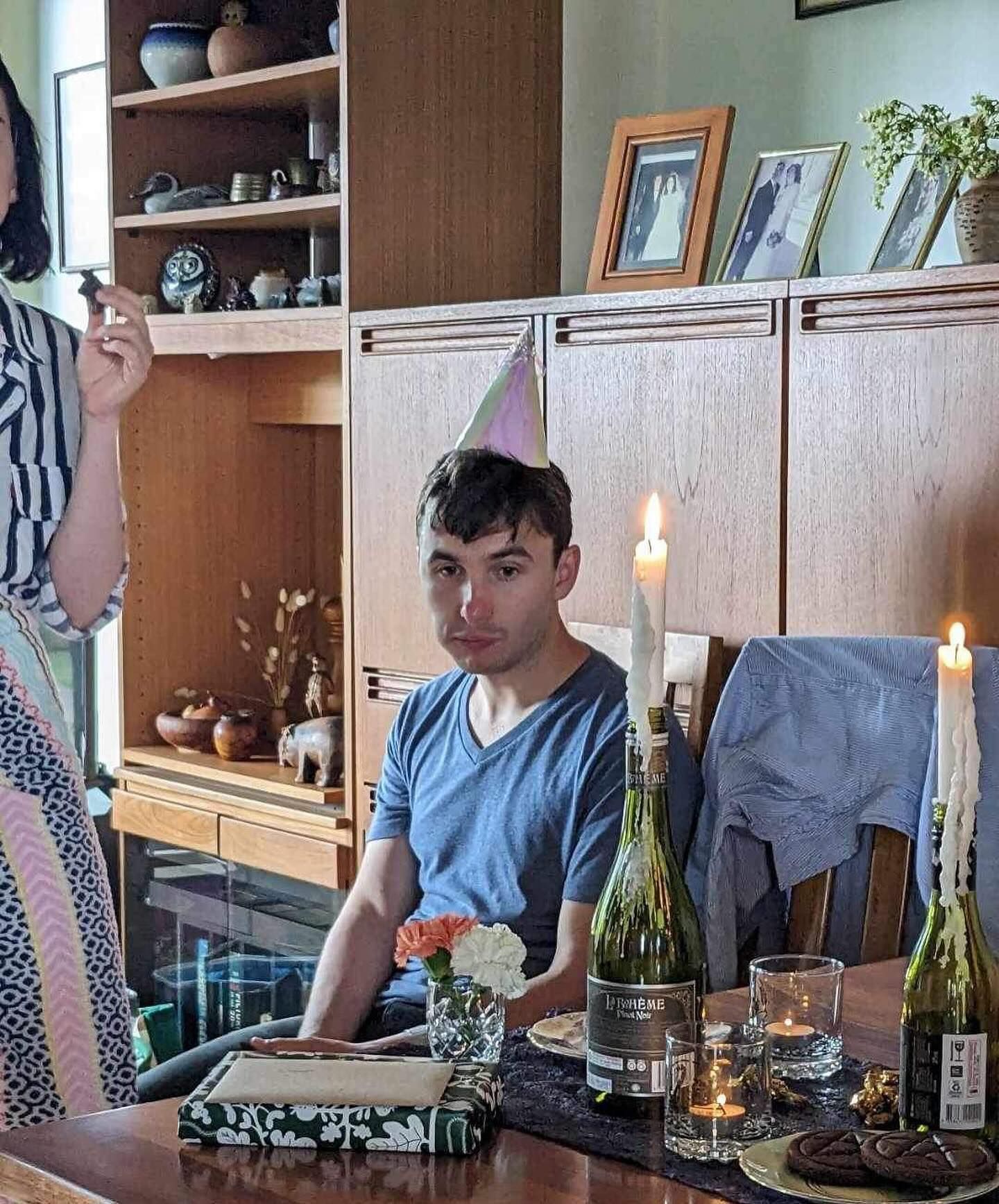 Jack is at the saddest birthday party ever. He has a party hat on and on the table in front of him are two bottles of champagne with candles burning in  them. There's a particularly 1960s-style grimness to the whole scene.